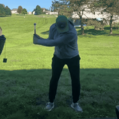 Animated demonstration of a golfer using Nextra® swing trainer on the course. Shows the stick extending and clicking to indicate proper release point and tempo.