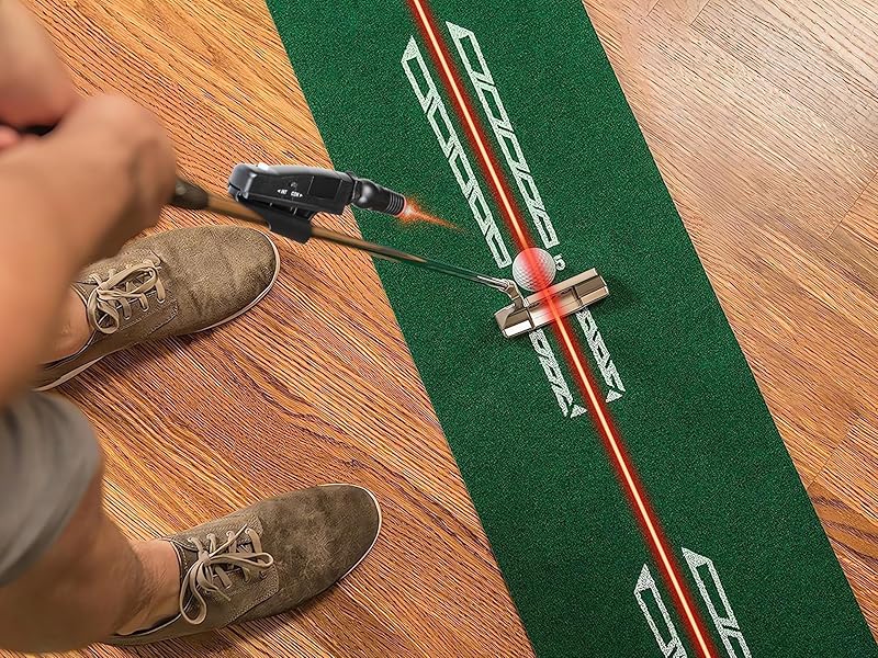 Person using a golf club on a mini golf course with a green mat and red laser line.